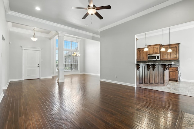 6137 Remington Dr, Bryant, AR 72022 - unfurnished living room with decorative columns, a ceiling fan, wood-type flooring, and crown molding