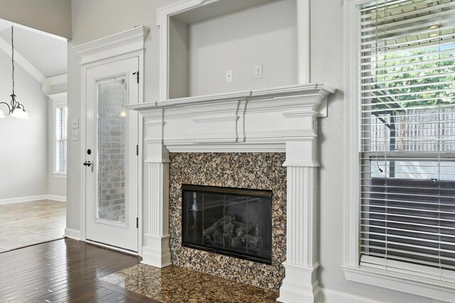 6137 Remington Dr, Bryant, AR 72022 - detailed view of wood finished floors, a high end fireplace, a chandelier, and ornamental molding