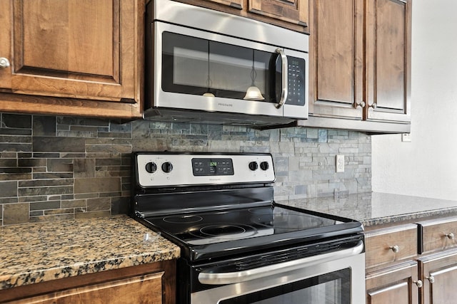 6137 Remington Dr, Bryant, AR 72022 - kitchen with stainless steel appliances, decorative backsplash, brown cabinets, and stone countertops