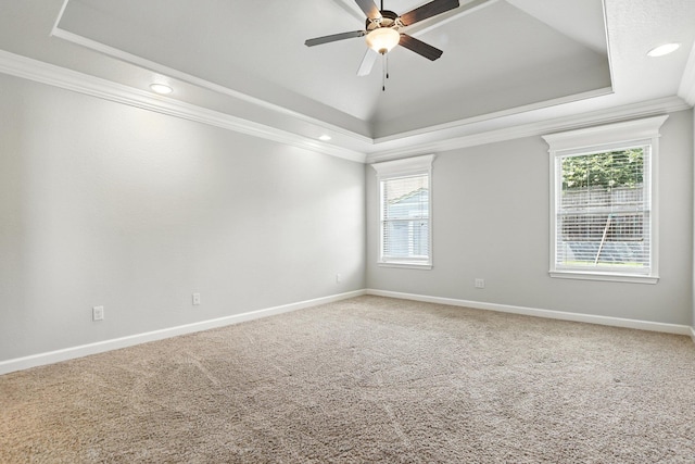 6137 Remington Dr, Bryant, AR 72022 - carpeted empty room featuring a raised ceiling, ornamental molding, plenty of natural light, a ceiling fan, and recessed lighting