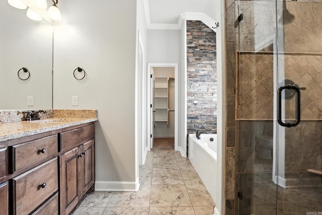 6137 Remington Dr, Bryant, AR 72022 - full bathroom featuring ornamental molding, vanity, a shower stall, a garden tub, and a walk in closet