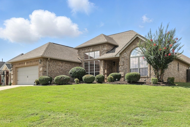 6137 Remington Dr, Bryant, AR 72022 - french country style house with brick siding, a garage, a shingled roof, a front yard, and driveway