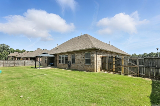 6137 Remington Dr, Bryant, AR 72022 - rear view of house with a gazebo, a patio area, brick siding, and a fenced backyard