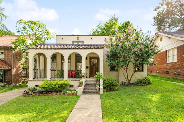 120 Crystal Ct, Little Rock, AR 72205 - mediterranean / spanish house featuring covered porch, stucco siding, and a front lawn