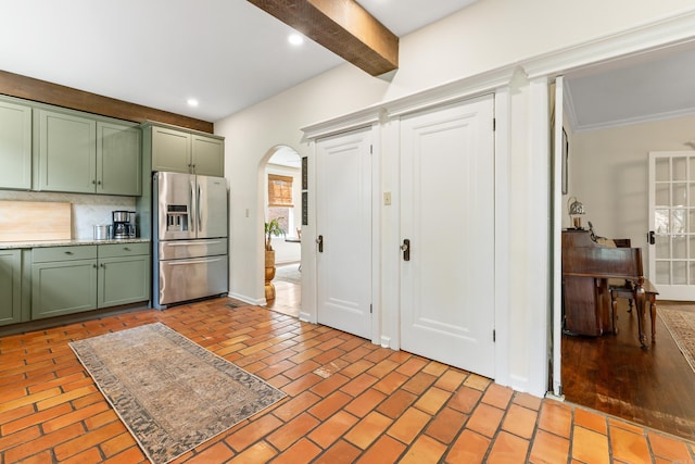 120 Crystal Ct, Little Rock, AR 72205 - kitchen featuring green cabinets, stainless steel refrigerator with ice dispenser, arched walkways, brick flooring, and beamed ceiling