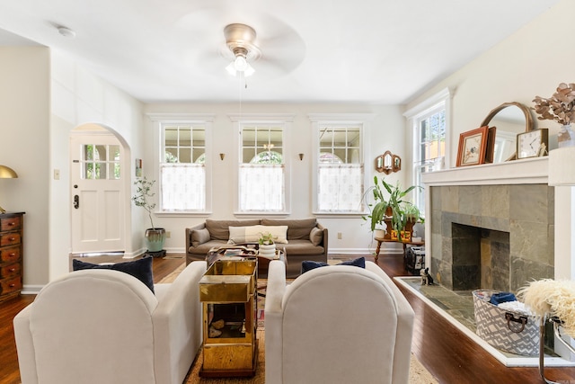 120 Crystal Ct, Little Rock, AR 72205 - living area with ceiling fan, dark wood-type flooring, a tiled fireplace, and arched walkways