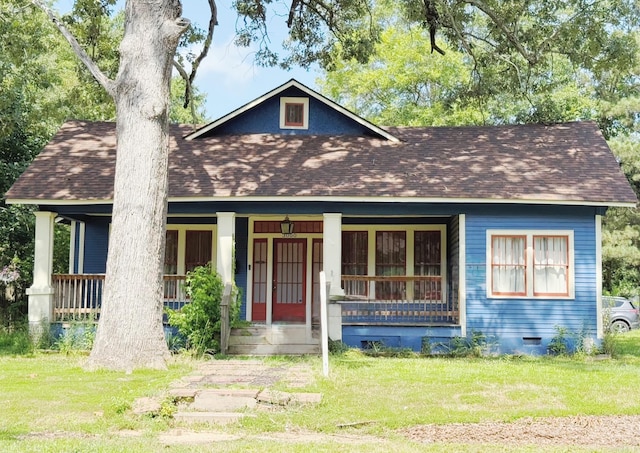 3000 S Cherry St, Pine Bluff, AR 71603 - view of front of house with roof with shingles, covered porch, and a front yard