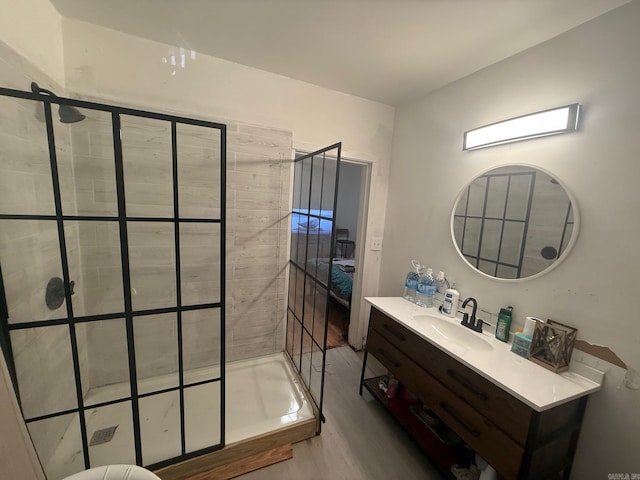 3000 S Cherry St, Pine Bluff, AR 71603 - full bathroom featuring a stall shower, vanity, and wood finished floors