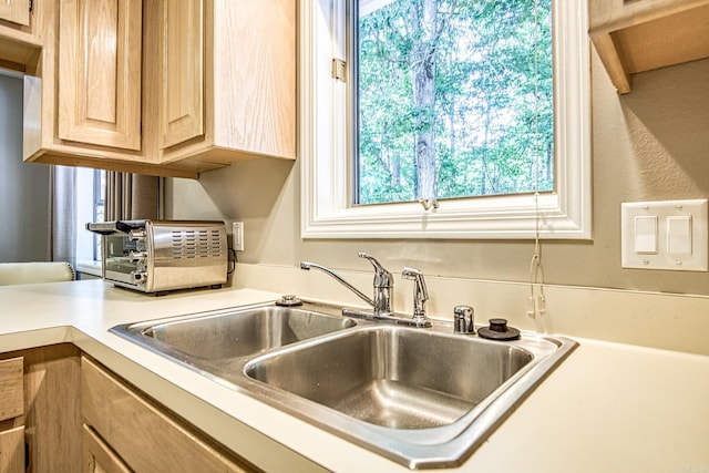 23 Emanuel Dr, Hot Springs Village, AR 71909 - kitchen with light brown cabinetry, healthy amount of natural light, and light countertops