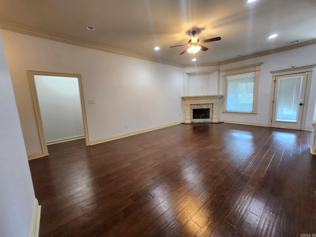 140 Bentley Cir, Little Rock, AR 72210 - unfurnished living room with ceiling fan, dark wood-style floors, ornamental molding, a fireplace with raised hearth, and recessed lighting