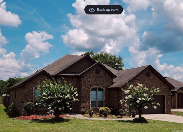 140 Bentley Cir, Little Rock, AR 72210 - view of front facade featuring brick siding, concrete driveway, a garage, and a front lawn