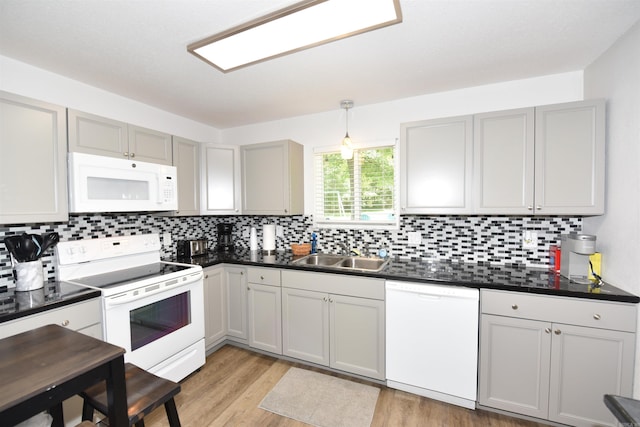 242 Lakeview Dr, Fairfield Bay, AR 72088 - kitchen with white appliances, dark countertops, light wood-style flooring, and decorative backsplash