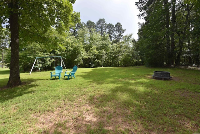 242 Lakeview Dr, Fairfield Bay, AR 72088 - view of grassy yard with an outdoor fire pit