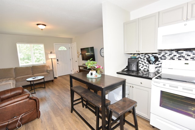 242 Lakeview Dr, Fairfield Bay, AR 72088 - kitchen featuring white appliances, open floor plan, tasteful backsplash, and light wood-type flooring