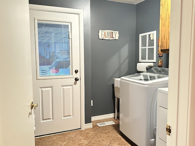 67 Powhatan Dr, Cherokee Village, AR 72529 - washroom with independent washer and dryer, cabinet space, and light tile patterned floors