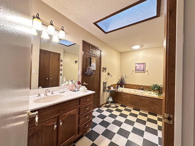 67 Powhatan Dr, Cherokee Village, AR 72529 - full bathroom with a textured ceiling, vanity, tile patterned floors, a bath, and a skylight