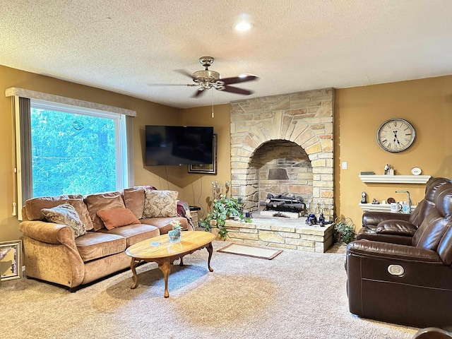 67 Powhatan Dr, Cherokee Village, AR 72529 - living room featuring a ceiling fan, carpet, a textured ceiling, and a stone fireplace