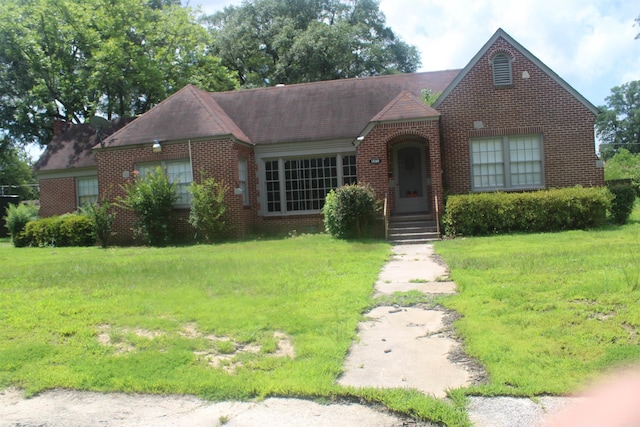 1300 W 28th Ave, Pine Bluff, AR 71603 - tudor house featuring brick siding and a front yard