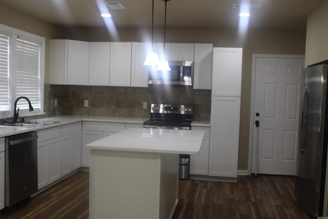 1300 W 28th Ave, Pine Bluff, AR 71603 - kitchen with appliances with stainless steel finishes, dark wood finished floors, white cabinetry, and light countertops