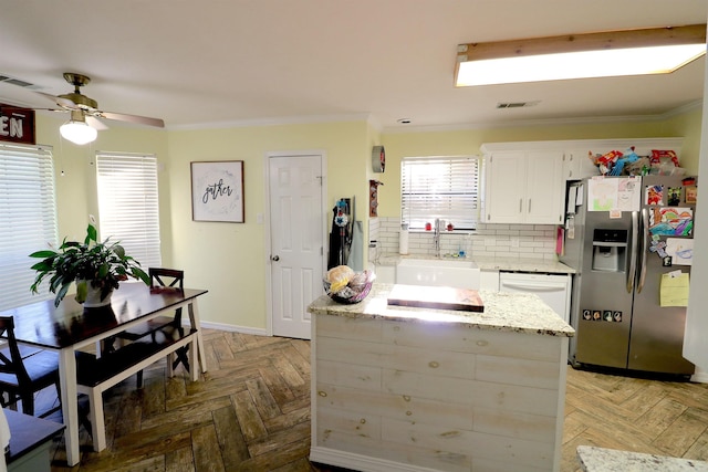 34 Ridge Rd, Cabot, AR 72023 - kitchen featuring stainless steel fridge, crown molding, white cabinetry, ceiling fan, and decorative backsplash