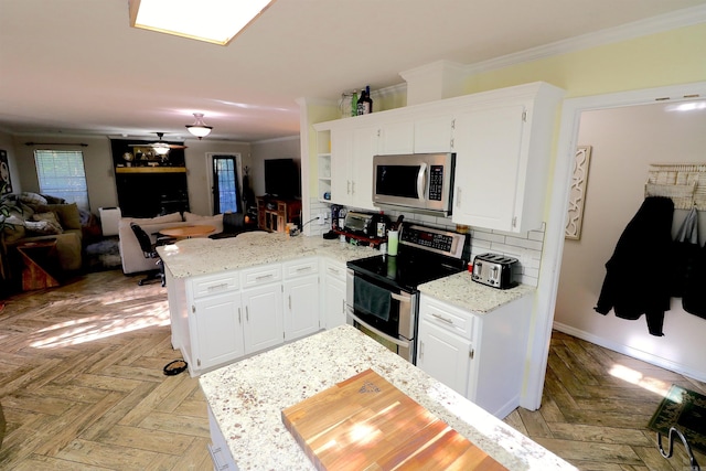 34 Ridge Rd, Cabot, AR 72023 - kitchen featuring stainless steel appliances, ornamental molding, a peninsula, and white cabinetry