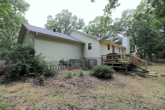 34 Ridge Rd, Cabot, AR 72023 - rear view of house with a deck and a chimney