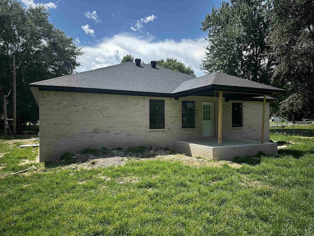 410 N Cedar St, Beebe, AR 72012 - rear view of house with brick siding, a yard, and a shingled roof