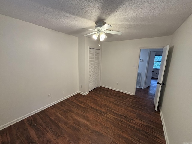11220 Bainbridge Dr, Little Rock, AR 72212 - unfurnished bedroom with dark wood-type flooring, a closet, a textured ceiling, and a ceiling fan