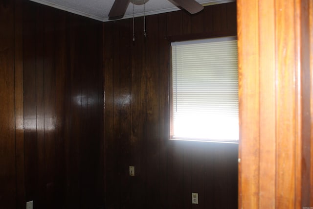 4406 W 16th Ave, Pine Bluff, AR 71603 - unfurnished room featuring wooden walls, a ceiling fan, and ornamental molding