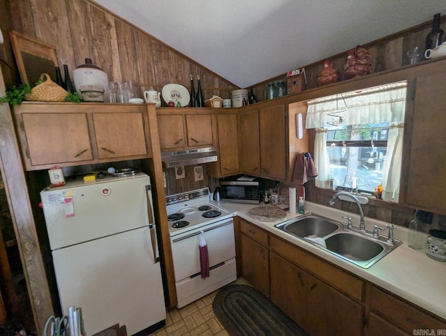 100 Osage, Edgemont, AR 72044 - kitchen featuring white appliances, under cabinet range hood, vaulted ceiling, light countertops, and brown cabinetry