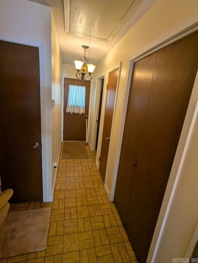 100 Osage, Edgemont, AR 72044 - doorway to outside featuring brick patterned floors and a chandelier