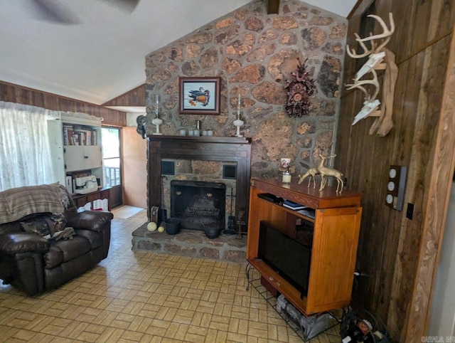 100 Osage, Edgemont, AR 72044 - living room featuring vaulted ceiling, a stone fireplace, brick patterned floors, and wood walls