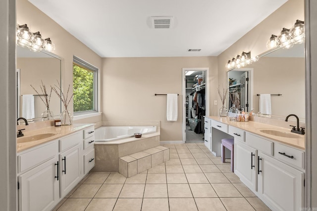 18 Calumet Rd, Little Rock, AR 72223 - bathroom featuring two vanities, a bath, tile patterned floors, and a spacious closet