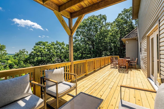 18 Calumet Rd, Little Rock, AR 72223 - deck featuring outdoor dining space and view of wooded area