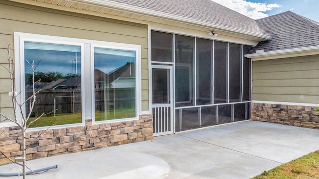 4321 Sloan Dr, Bryant, AR 72002 - view of exterior entry featuring a patio, roof with shingles, and stone siding