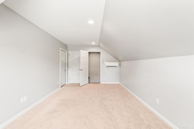 4321 Sloan Dr, Bryant, AR 72002 - additional living space featuring a wall unit AC, vaulted ceiling, recessed lighting, and light carpet