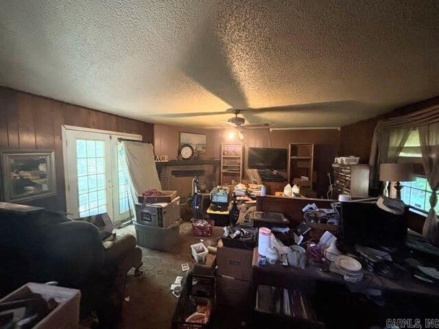 9105 Sunset Ln, Little Rock, AR 72209 - living room featuring a ceiling fan, a textured ceiling, wooden walls, and carpet floors