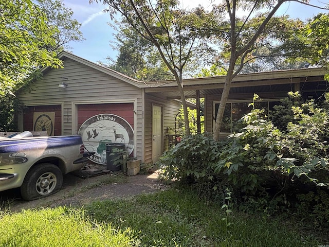 9105 Sunset Ln, Little Rock, AR 72209 - view of home's exterior featuring an attached garage and driveway