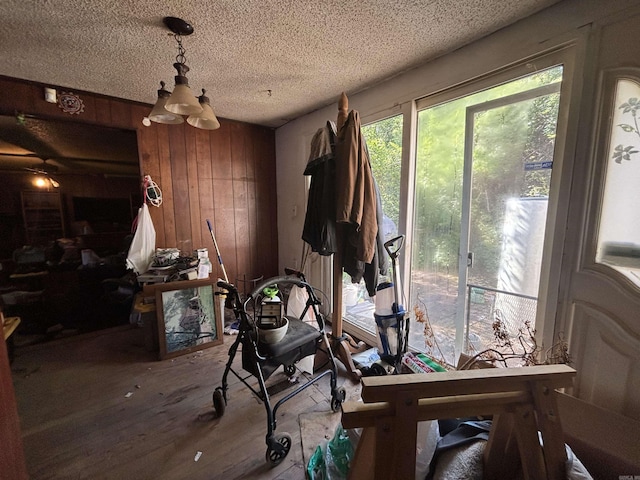 9105 Sunset Ln, Little Rock, AR 72209 - dining room with wood finished floors, wooden walls, and a textured ceiling