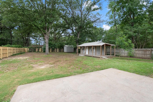 1495 Manor St, Conway, AR 72034 - fenced backyard with a storage unit, a patio area, and view of scattered trees