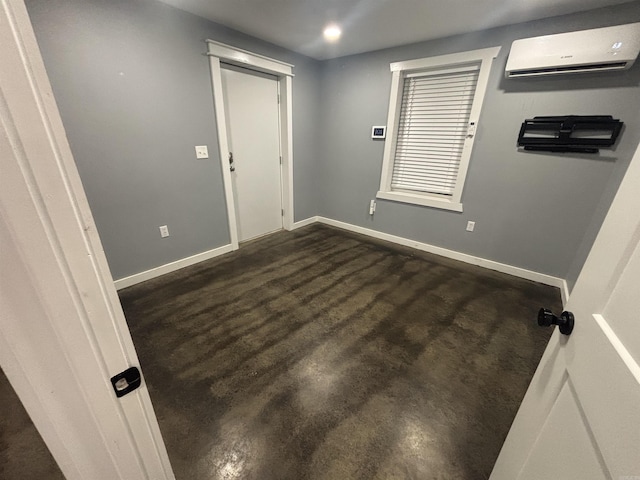 225 Donnie Holt Rd, Mcrae, AR 72102 - spare room featuring an AC wall unit and baseboards