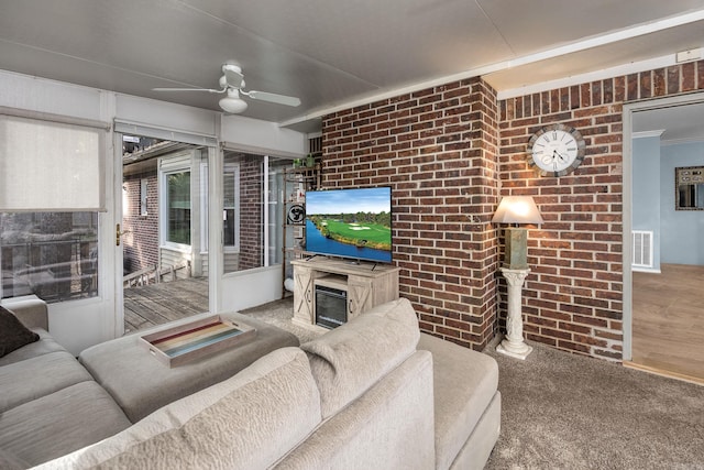 914 Cartier Ln, Little Rock, AR 72211 - living room with a ceiling fan, brick wall, carpet floors, and crown molding