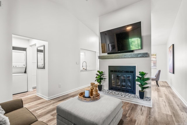 301 Kings Row Dr Unit 106, Little Rock, AR 72207 - living room with high vaulted ceiling, wood finished floors, and a glass covered fireplace