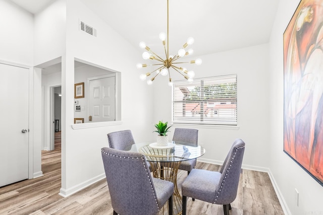301 Kings Row Dr Unit 106, Little Rock, AR 72207 - dining room featuring a chandelier, light wood-type flooring, and high vaulted ceiling