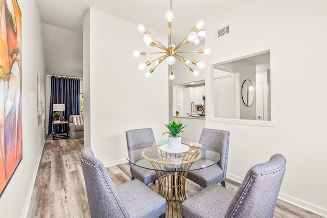 301 Kings Row Dr Unit 106, Little Rock, AR 72207 - dining room featuring a chandelier, wood finished floors, and a high ceiling