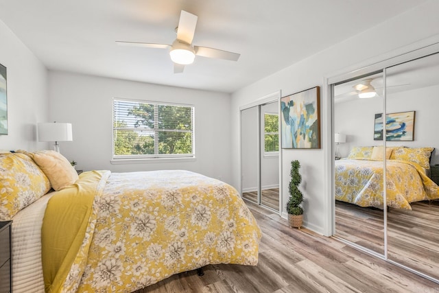 301 Kings Row Dr Unit 106, Little Rock, AR 72207 - bedroom featuring two closets, wood finished floors, and ceiling fan