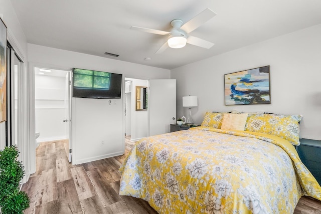 301 Kings Row Dr Unit 106, Little Rock, AR 72207 - bedroom with wood finished floors, a ceiling fan, and a closet