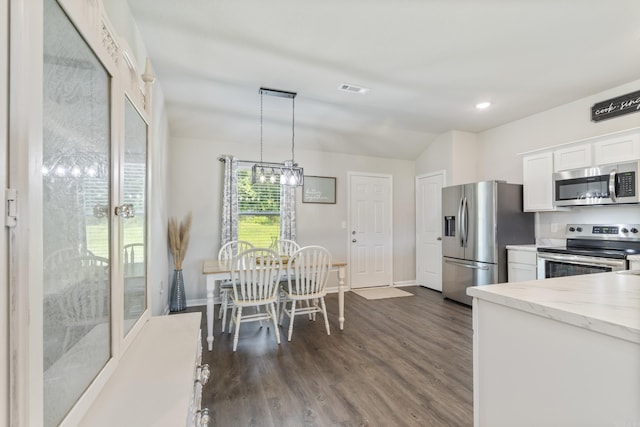 1040 Gallery Dr, Conway, AR 72032 - kitchen featuring stainless steel appliances, white cabinets, dark wood-type flooring, light stone counters, and decorative light fixtures