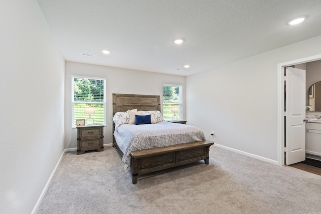 1040 Gallery Dr, Conway, AR 72032 - carpeted bedroom with multiple windows, recessed lighting, and ensuite bath