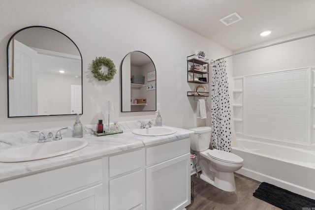 1040 Gallery Dr, Conway, AR 72032 - full bath featuring wood finished floors, double vanity, and shower / bath combination with curtain